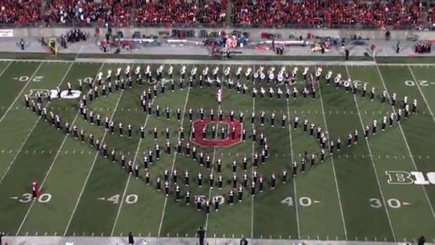 The marching band make the Superman symbol.