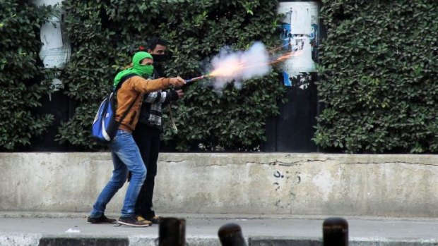 A Muslim Brotherhood supporter aims fireworks at supporters of the Egyptian government in Cairo.