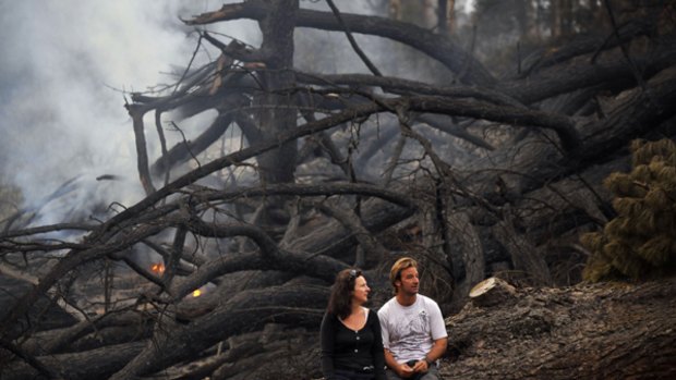 Megan and Shayne Cheney, who lost their dream home in Koornalla, sit in what was once a popular camping site nearby. The couple escaped the flames by minutes.