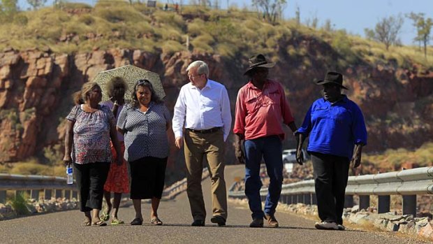 It's all uphill: Kevin Rudd and a group of traditional owners walk across the Ord River Dam near Kununurra.