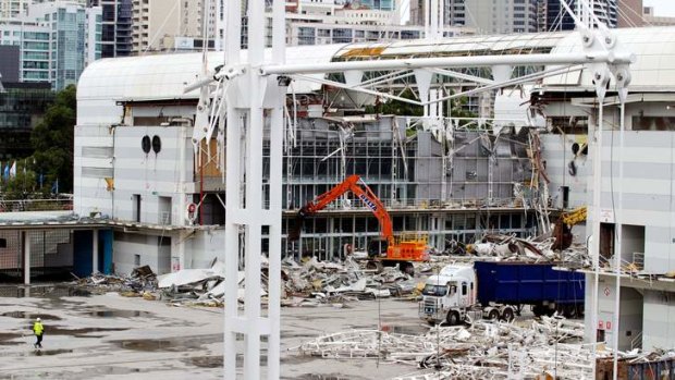 Going, going: The Darling Harbour Exhibition Centre, which was opened by the Queen in 1988, is pulled down to make way for a billion dollar development.