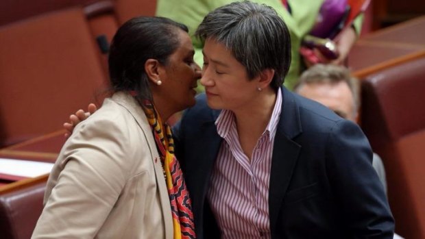Senator Nova Peris is embraced by Opposition Leader in the Senate Penny Wong following her statement. 