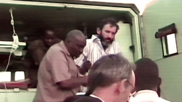 A video grab from French TV channel LCI shows French intelligence agent (top right) who was kidnapped last month by hardline Islamists in Somalia, being helped out of a car after he escaped from his captors in Mogadishu.