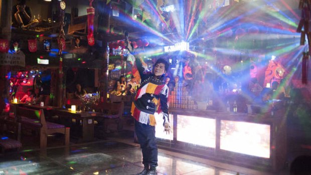 Party people: A man in Naxi dress performs.