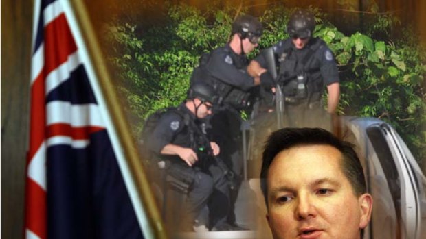Another riot ... The Immigration Minister Chris Bowen, and (inset), police at Christmas Island in March, 2011.