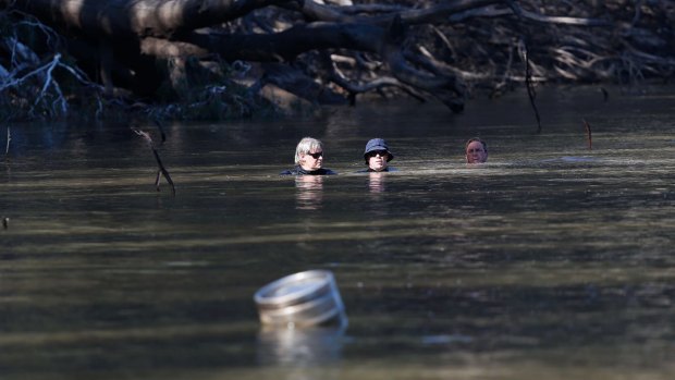 Divers search for the five-year-old boy who was later found dead in the river.