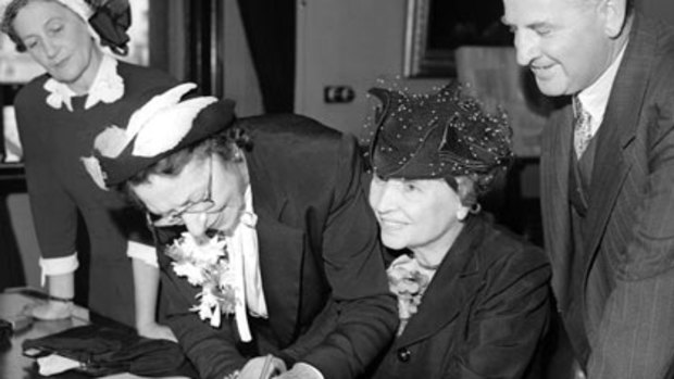 lind and deaf writer Helen Keller signing the visitors book at Sydney Town Hall with assistance from secretary Polly Thompson on March 31, 1948.