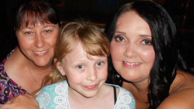 Karrisa McDonald (centre), pictured with her sister and mum, died after being hit by an umbrella picked up by a gust of wind at Anzac Pool on Thursday.