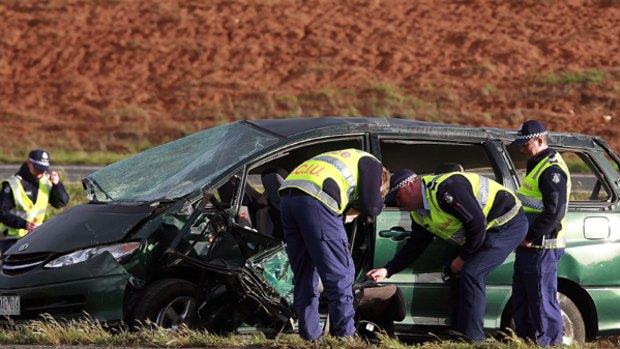 Police inspect the vehicle involved in the crash on the Western Highway in Melton.