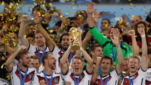 Germany's Bastian Schweinsteiger holds up the World Cup in 2014.
