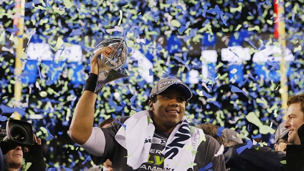 Seattle quarterback Russell Wilson celebrates with the Vince Lombardi Trophy.