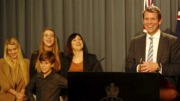 Rosebud family: Mike Baird addresses the media, with wife Kerryn and their children.