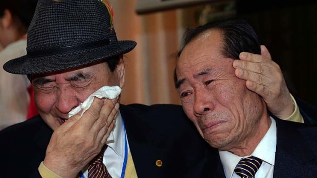 South Korean Jung Hee-Kyung (left) bids farewell to his North Korean relative.