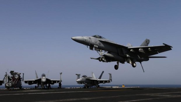 A Super Hornet landing on the flight deck of the aircraft carrier USS George H.W. Bush, in the Persian Gulf.