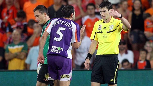 Steve Pantelidis of the Glory shows his frustration as he questions referee Jarred Gillett over his decision to award the Roar a penalty.