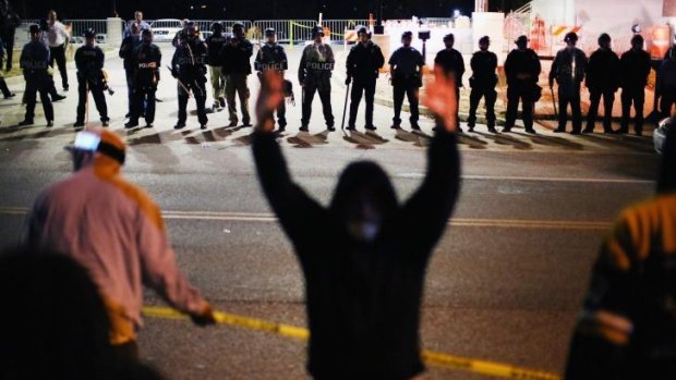 Police face off with demonstrators after the leaks in the Michael Brown grand jury inquiry on Wednesday. Officials expect widespread riots if police officer Darren Wilson is not indicted in November.