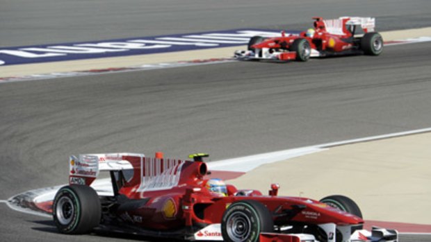 Ferrari driver Fernando Alonso of Spain steers his car ahead of Ferrari driver Felipe Massa.
