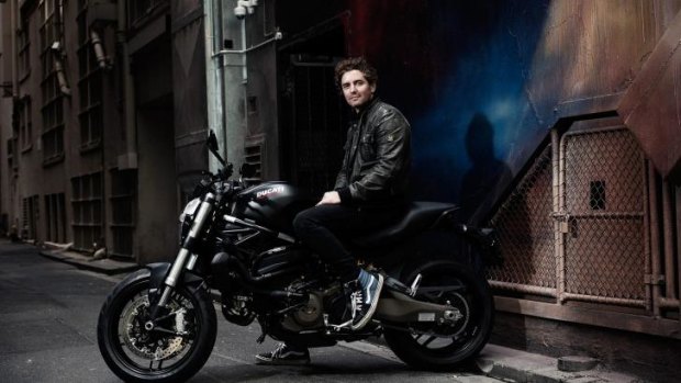 Portrait of an artist: Vincent Fantauzzo  on his motorbike in a Melbourne laneway.