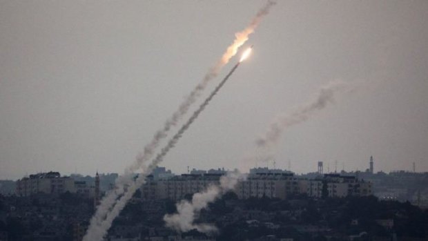 Barrage: A picture taken from the southern Israeli-Gaza border shows a rocket being launched from the Gaza Strip into Israel.