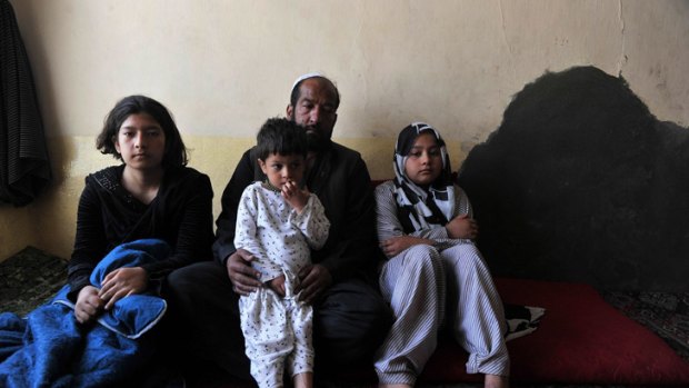 Tarana Akbari, right, sits in her Kabul home with her father, sister and brother.