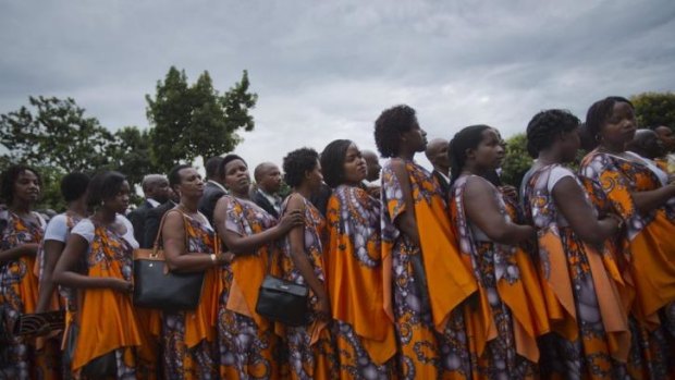 Rwandan women arrive in Kigali to take part in a procession following a small flame of remembrance, with the symbolic fire travelling the country to commemorate the genocide anniversary.
