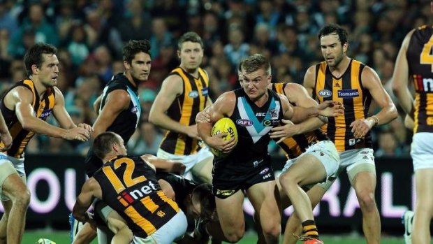 Powering through: Ollie Wines leaves a flock of Hawks in his wake as Port Adelaide downs Hawthorn by 14 points in round 10.
