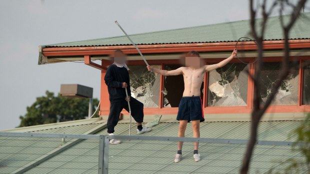 Youths protesting on the roof of the Melbourne Youth Justice Centre at Parkville in March.