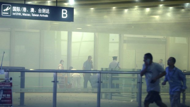 A photo released by China's Xinhua News Agency of medical workers and policemen after the homemade bomb exploded in terminal 3 of Beijing's international airport.