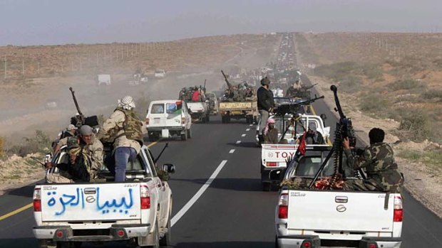 A convoy of rebels heads east from Ras Lanouf towards Sirte.