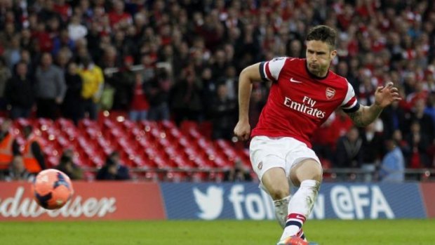 Arsenal's striker Olivier Giroud scores during the penalty shootout.
