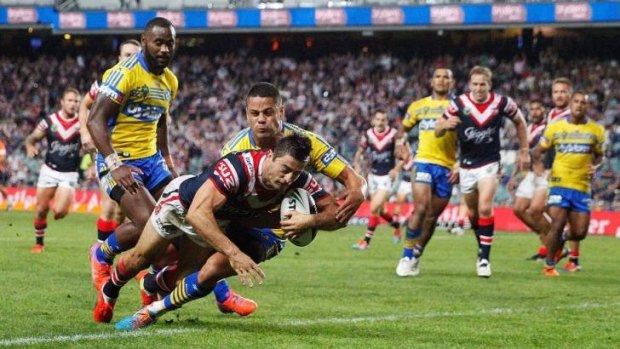 Good things come in threes: Anthony Minichiello scores one of his three tries against the Eels.