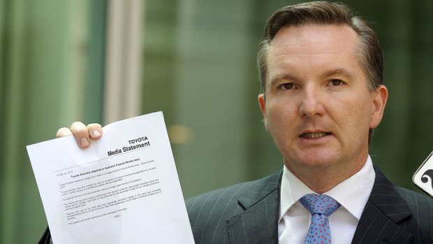 Quick to act: Shadow treasurer Chris Bowen brandishes the Toyota statement of denial at Parliament House on Wednesday.