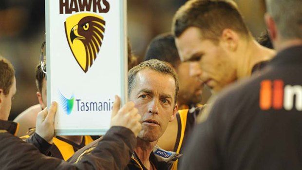 Hawthorn's coach Alastair Clarkson maps out strategy at quarter-time.