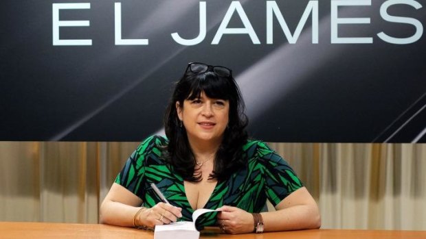 British author EL James signs a copy of her new book 'Grey: Fifty Shades of Grey' as Told by Christian" for a fan at the Barnes and Noble store on Fifth Avenue in New York.