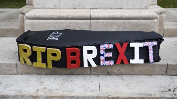 A mock funeral casket decorated with the words 'RIP Brexit' sits on display during an anti-Brexit protest outside the Houses of Parliament in London, UK.