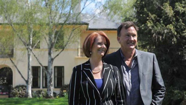 Proud new tenants: Prime Minister Julia Gillard and her partner Tim Mathieson pose for the media in the garden of the Lodge.