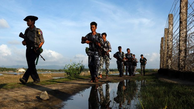 Myanmar police officers patrol  the border between Myanmar and Bangladesh in October. An attack on police at the border in October sparked the latest surge of violence.