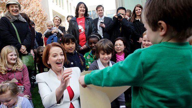 Energised: Julia Gillard meets mothers and children at Parliament House yesterday.