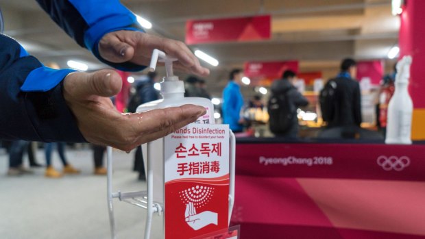 Precaution: A man sanitizes his hands at the entrance to the media cafeteria in Gangneung.