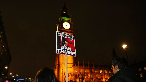 Demonstrators hold a banner during a protest against U.S President Donald Trump's controversial travel ban on refugees and people from seven mainly-Muslim countries, in London, Monday, Jan. 30, 2017. On Friday President Trump signed an executive order halting the US refugee programme for 120 days, indefinitely banning all Syrian refugees and suspended issuing visas for people from Iran, Iraq, Libya, Somalia, Sudan, Syria or Yemen for at least 90 days. (AP Photo/Alastair Grant)