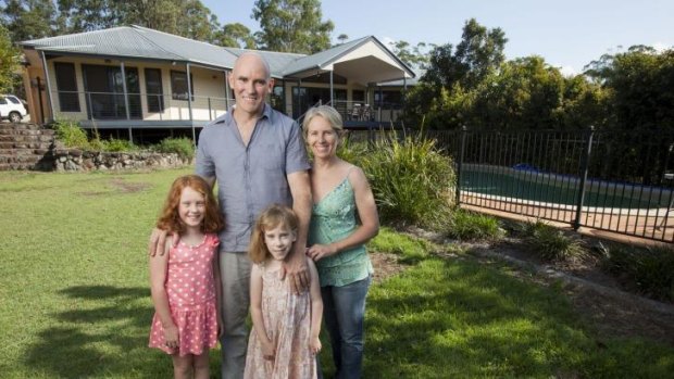 Interstate commuter Belinda Kerr at home on Queensland's Sunshine Coast with husband Michael Trehy and daughters Molly, left, and Ivy.