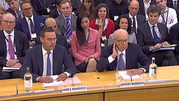James and Rupert Murdoch face a British parliamentary inquiry into phone hacking last night. Rupert Murdoch's wife, Wendi Deng, watches in the background.