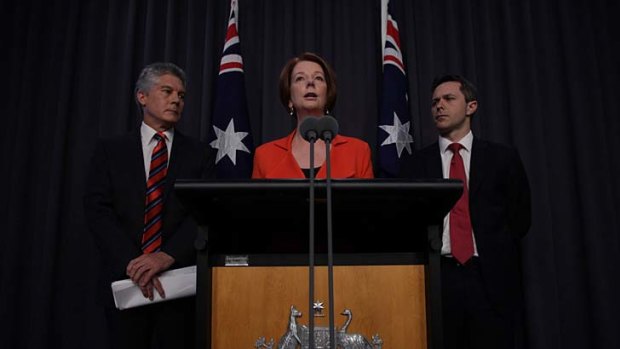 The Gillard government announces cuts to Defence spending - while revealing a $214 million in funding for 12 submarines.