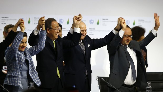 United Nations climate change chief Christiana Figueres, left, UN Secretary-General Ban Ki-moon, French Foreign Affairs Minister and UN Climate Change Conference in Paris president Laurent Fabius and French President Franois Hollande celebrate an agreement on climate change.