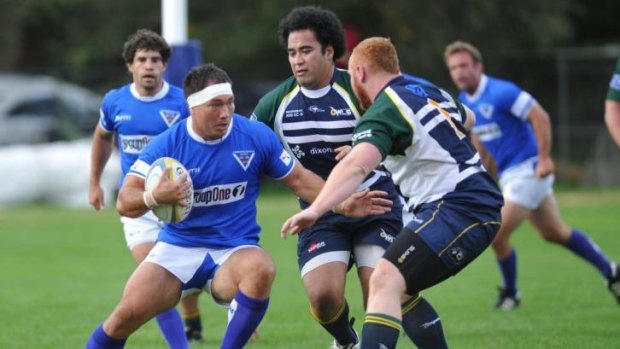 Royals hooker Robbie Abel (left) takes on Uni-Norths Owls defenders Richard Taumoepeau and Scott Meakins at ANU North Oval on Saturday. Abel is contracted to the Western Force.