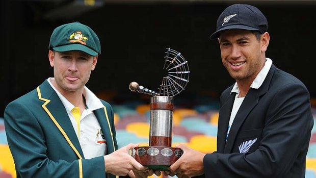 Michael Clarke and Ross Taylor pose with the trophy.