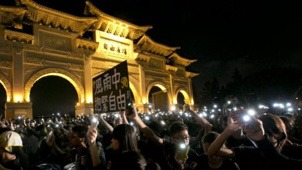 Cell phone showing: A rally in Taipei to show support for Hong Kong pro-democracy protests.