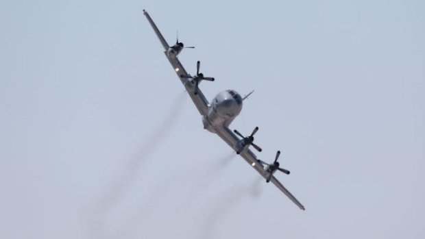 A RAAF Orion aircraft in flight during an air show.