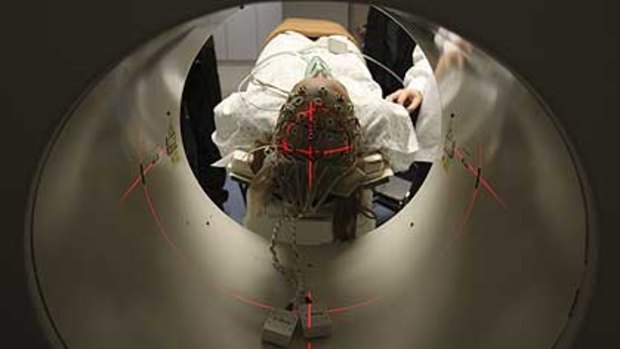 A patient is scanned in a machine similar to that used to discover Rom Houben, bottom left and right, was not brain dead.