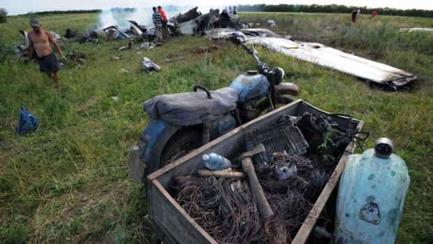 Villagers rushed to the wreck of a Ukrainian AN-26 military transport when it was shot down.